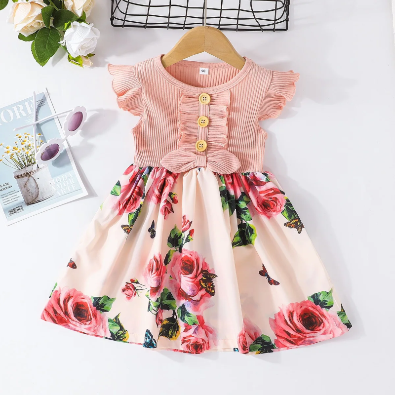 Pink floral dress on a hanger with flutter sleeves and a waist bow