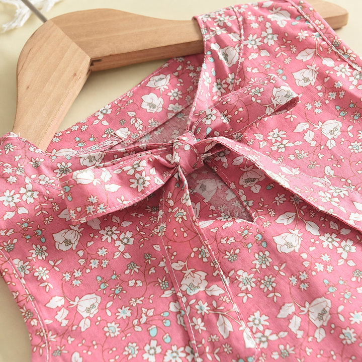 Bow and collar detail on the pink sleeveless floral top