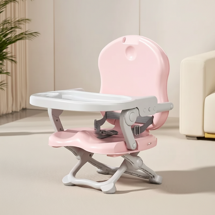 Pink compact high chair with a white tray and folding base