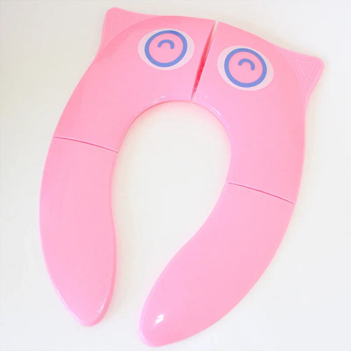 Pink folding toilet training seat with blue eye graphics