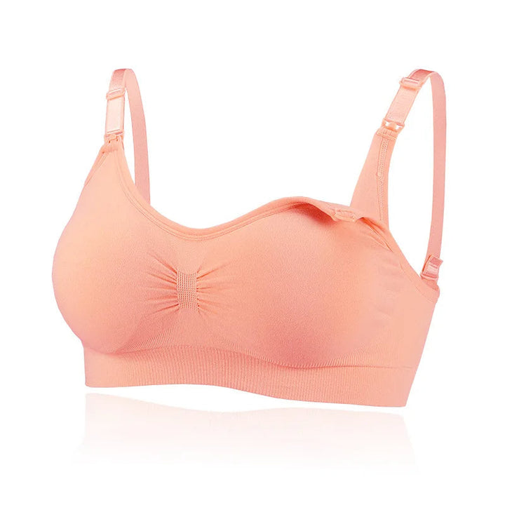 Pink wire-free nursing bra with a gathered front and nursing clips at the straps.