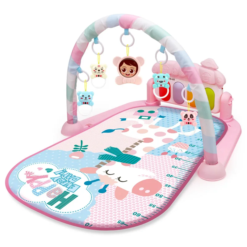 Pink giraffe-print baby gym with a pastel-striped arch and piano panel