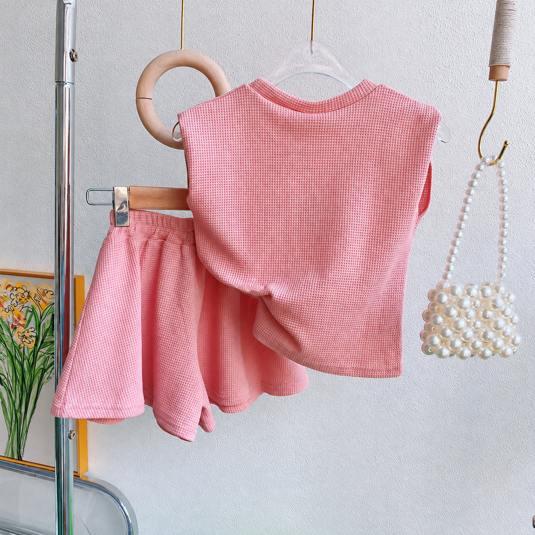 Back view of the pink sleeveless top and matching shorts on hangers