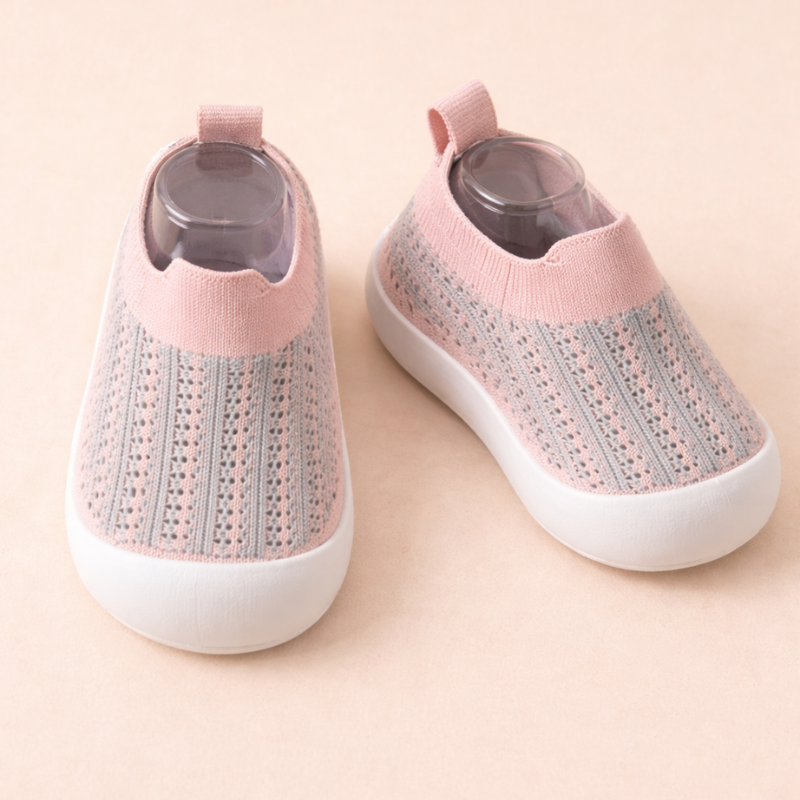 Pink and gray striped slip-on sneakers with pink cuffs and white soles.
