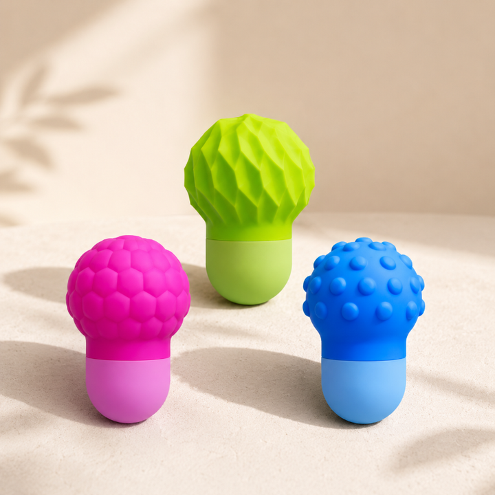Pink honeycomb, green faceted, and blue bumpy silicone bath squirters standing together