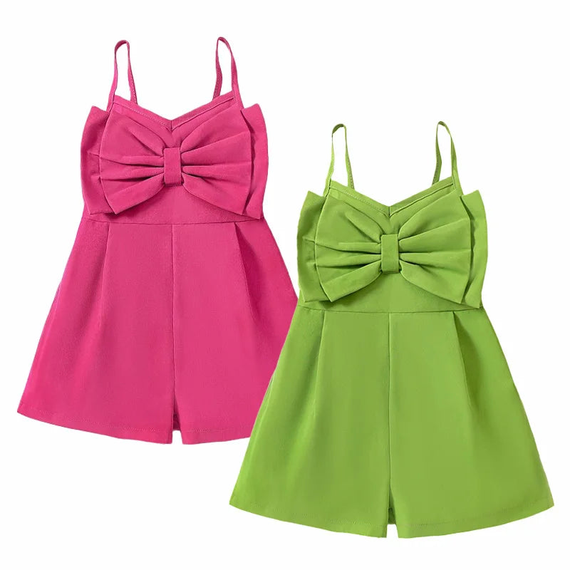 Pink and green kids' rompers with oversized front bows, slim straps and wide-cut shorts