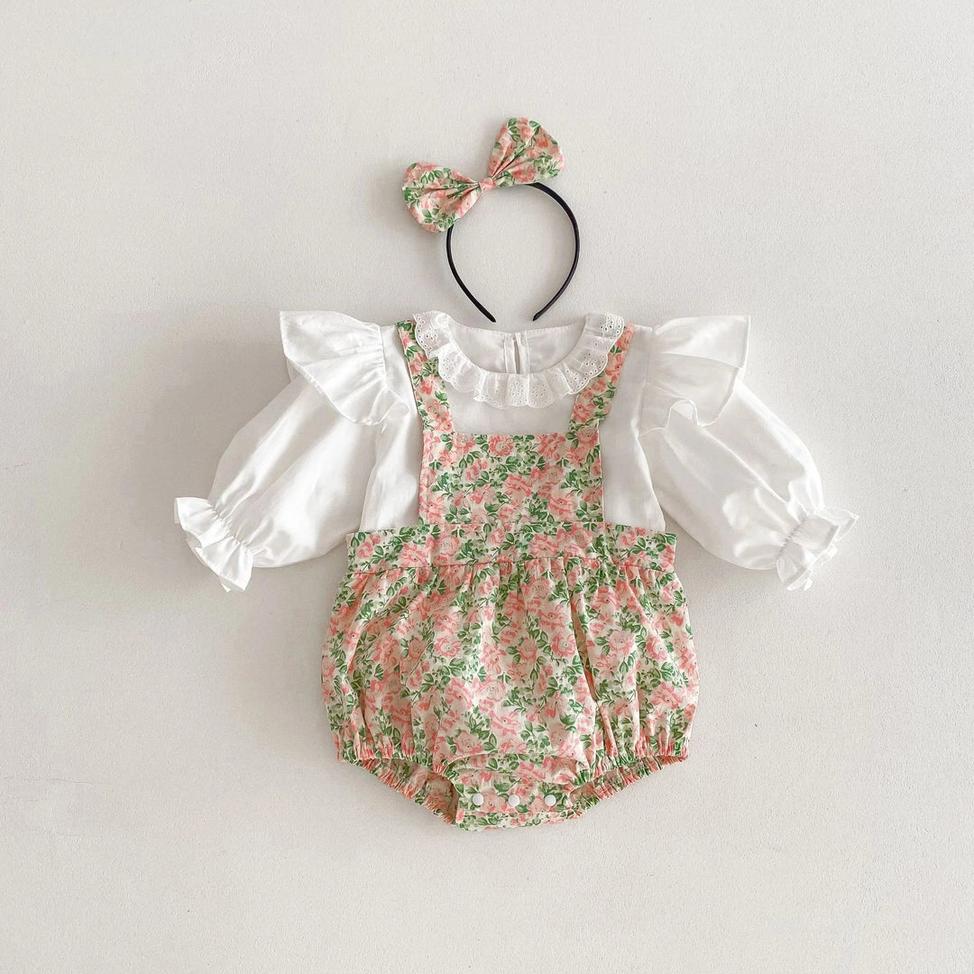 White ruffled top with a pink-and-green floral bodysuit and matching bow headband