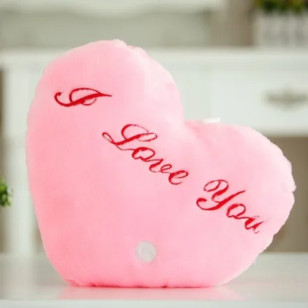 Pink heart-shaped plush pillow with red I Love You embroidery