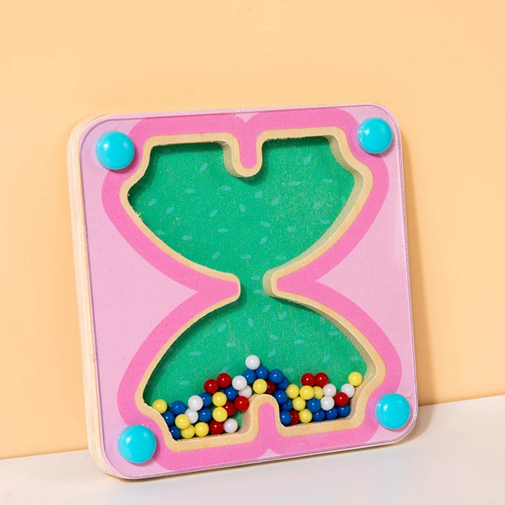 Pink hourglass-shaped activity board with small colorful beads behind a clear cover.