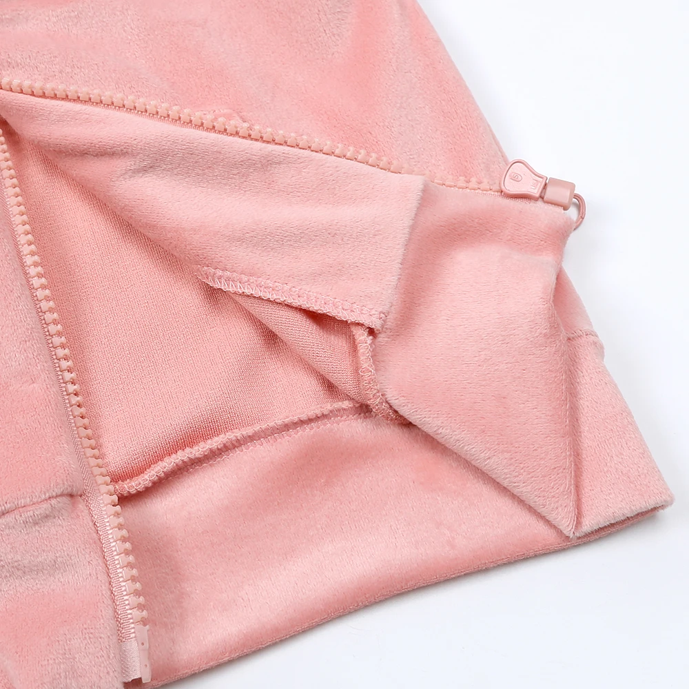 Folded-back edge of the pink jacket showing the inner fabric and stitched seams