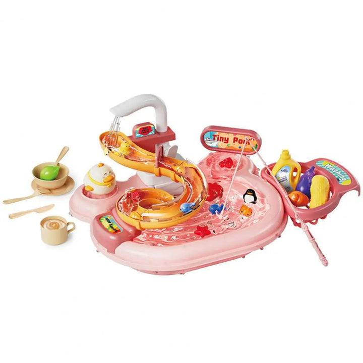 Pink play kitchen sink with a faucet, curved track, fishing rod, toy dishes, and play food