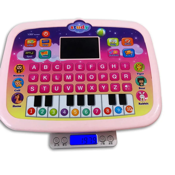 Pink learning toy tablet on a digital scale, showing alphabet buttons and numbered piano-style keys