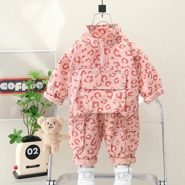 Pink leopard print two-piece outfit with a front-pocket pullover and gathered pant cuffs.