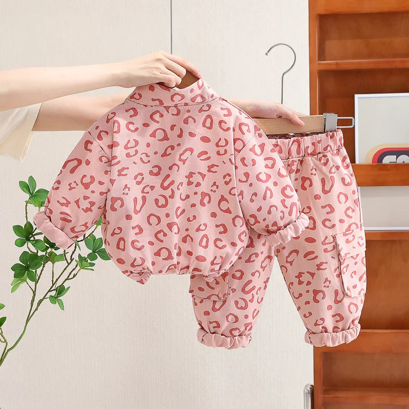 Pink leopard print top with a short front zipper and matching elastic-waist pants.
