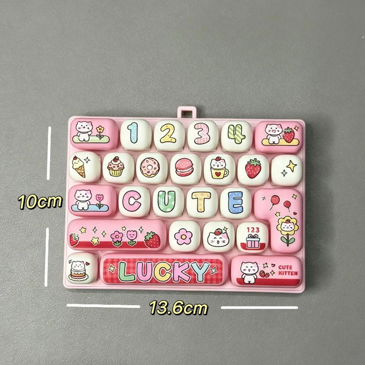 Pink fidget keyboard measurement graphic showing 13.6 cm width and 10 cm height