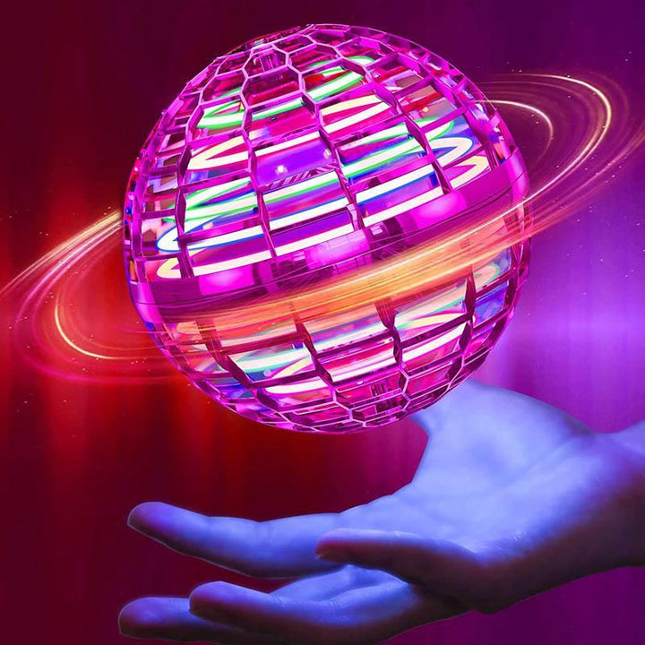 Pink mini drone ball with multicolored lights shown above an open hand