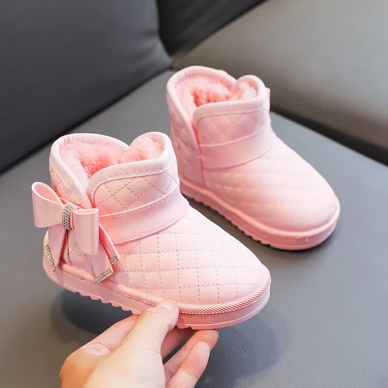 Pink quilted winter boots with matching bows and soft pink lining