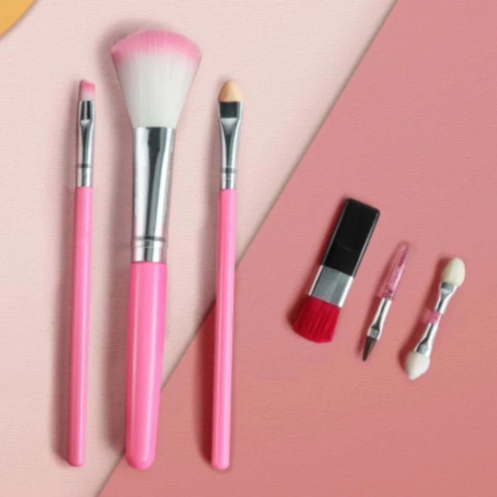 Pink-handled makeup brushes, lipstick and applicators on a two-tone pink background