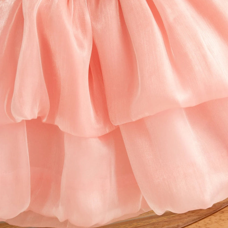 Close-up of the pink mesh dress showing its two-tier skirt