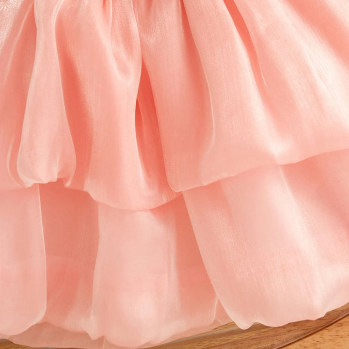Close-up of the pink mesh dress showing its two-tier skirt
