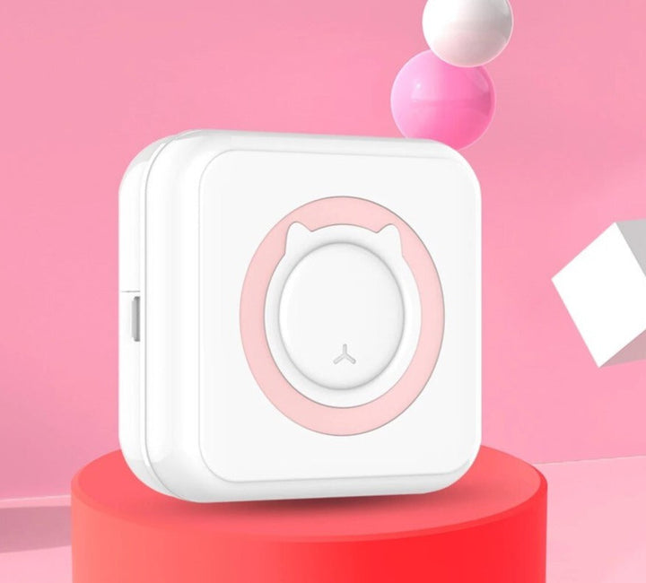 White mini photo printer with pink trim and a cat-shaped front detail