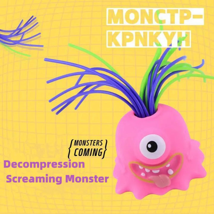 Pink one-eyed monster stress toy with long purple and green hair on a yellow background