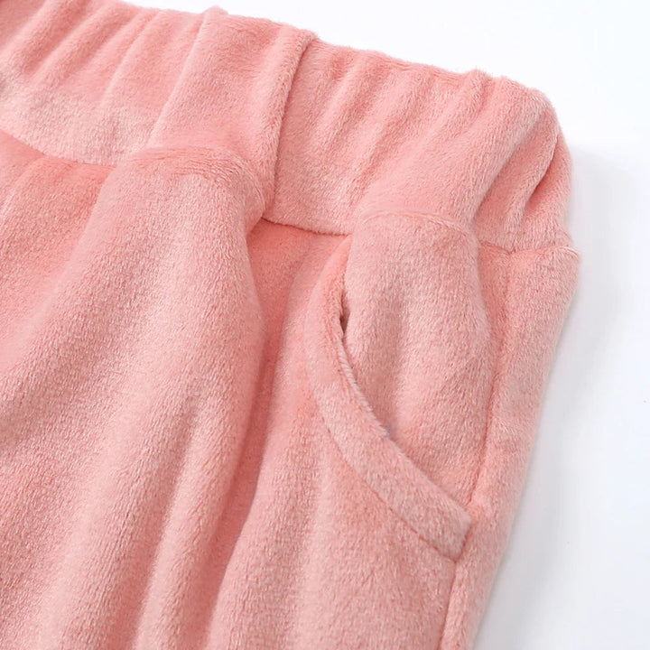 Pink pants turned back at the waist to show the inner waistband and pocket stitching