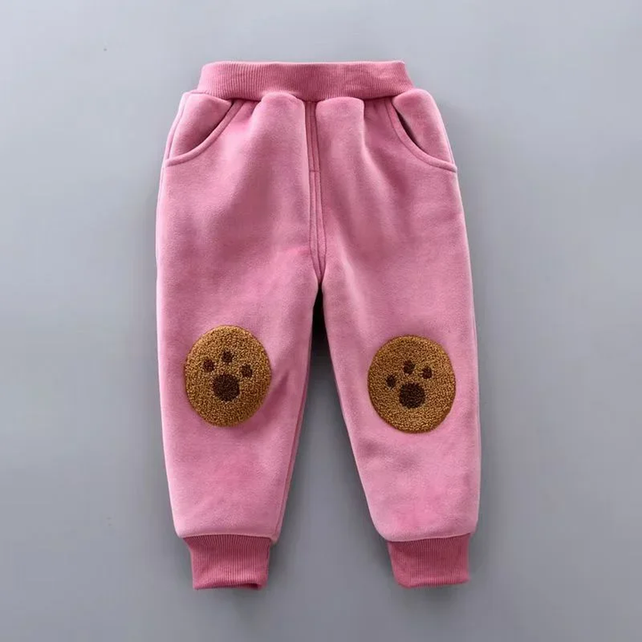 Pink elastic-waist pants with pockets, ribbed cuffs, and round bear-paw patches