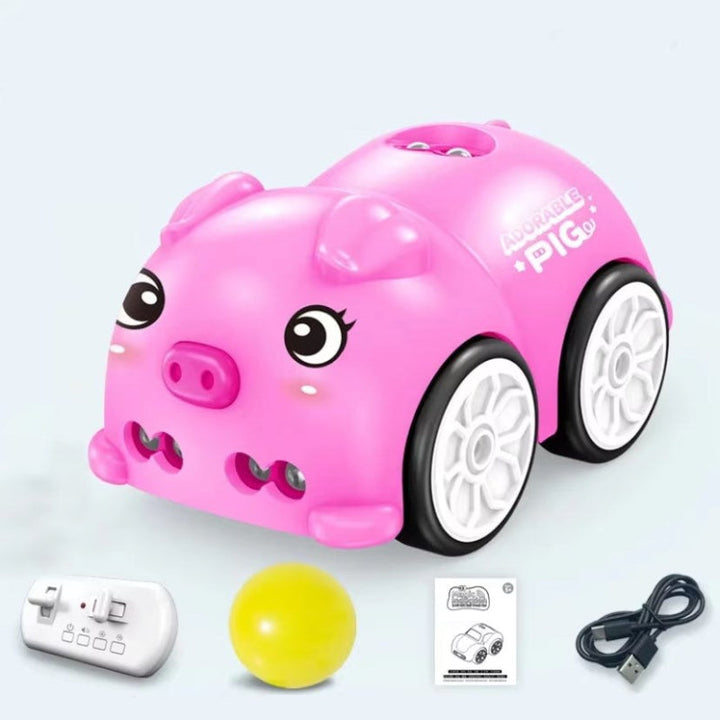 Pink piglet car with remote controller, yellow ball, charging cable, and instruction booklet