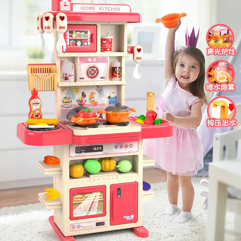 Child holding an orange toy pan beside a pink play kitchen with cookware and play food.