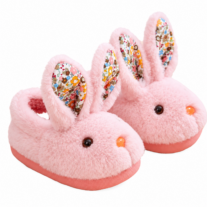Pair of pink plush bunny slippers with floral ears and pink soles