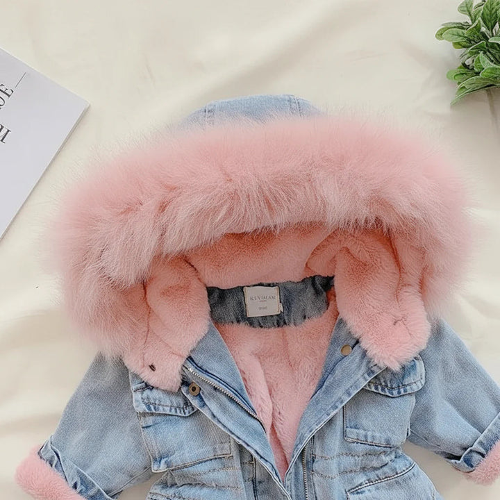 Close-up of the pink plush hood trim and lining on a denim-look winter coat