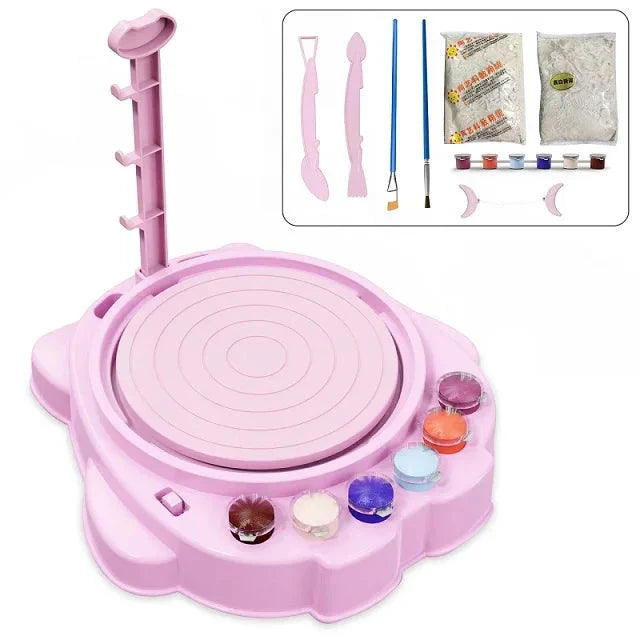 Pink pottery wheel set with paint pots, sculpting tools, brushes and clay shown in an inset