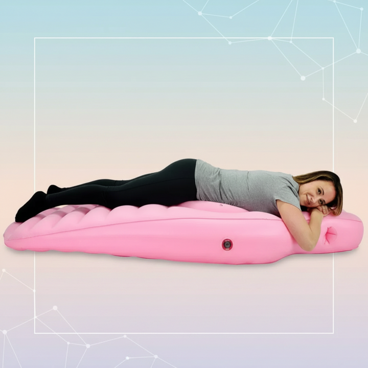 Woman resting on a pink inflatable pregnancy pillow