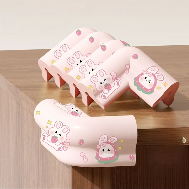 Five pink rabbit-print corner covers on a wooden cabinet, including one fitted to the corner.