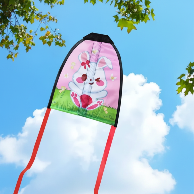 White rabbit handheld kite with a pink background and red ribbon tails