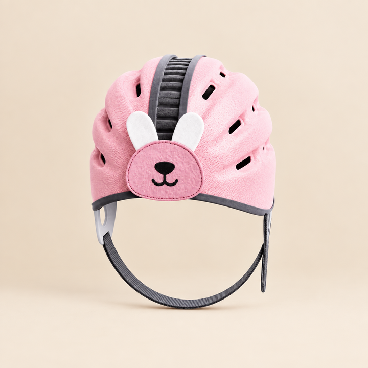 Pink rabbit headguard with long ear details and a chin strap