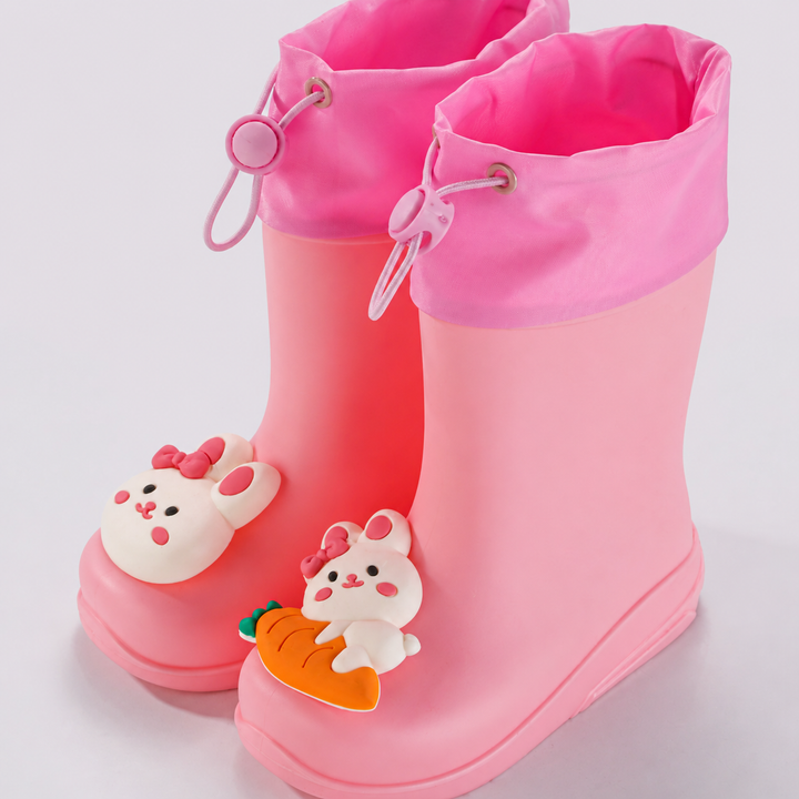 Pink rain boots with rabbit and carrot decorations and drawstring cuffs