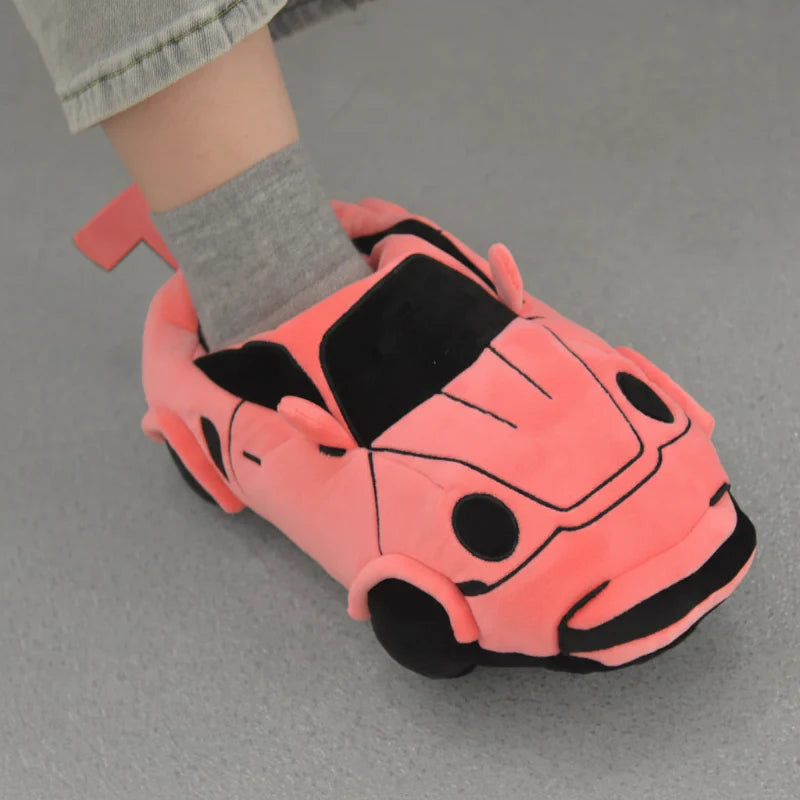 Pink racing car slipper worn with a gray sock, showing black windows and wheel details