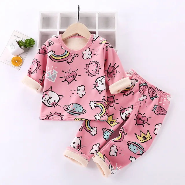 Pink cartoon-print pajama set with rainbows, hearts, and cream cuffs