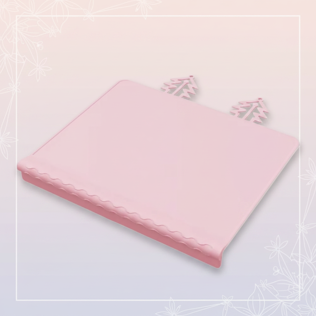 Pink silicone placemat with raised edging and two tree-shaped tabs