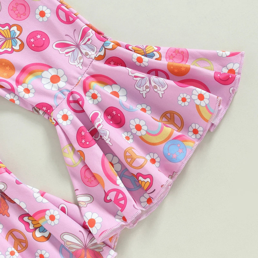 Pink flared pant legs printed with flowers, butterflies and peace signs.