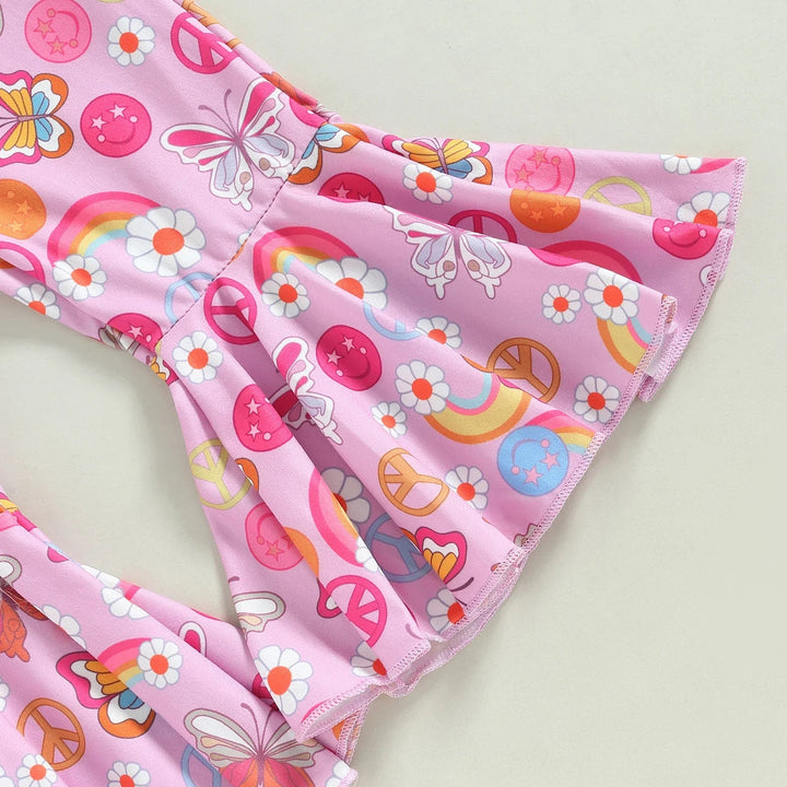 Pink flared pant legs printed with flowers, butterflies and peace signs.