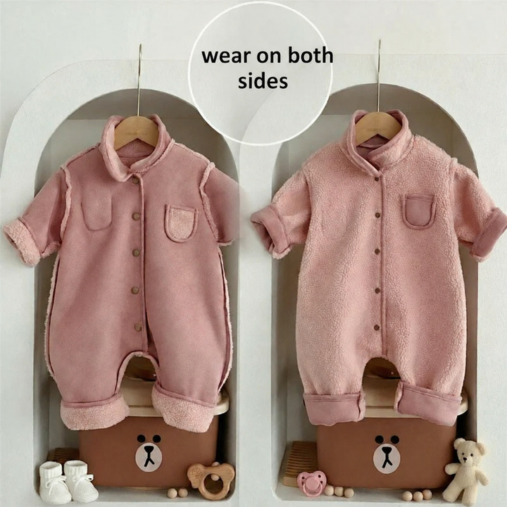 Pink reversible baby romper shown with the smooth side and fleece side facing out