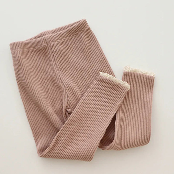 Pink ribbed leggings with an elastic waistband and pale lace edging at the cuffs.