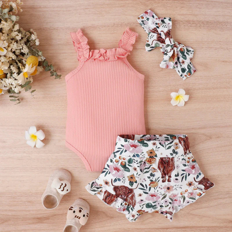 Pink ribbed baby romper with floral and animal-print shorts and a matching bow headband