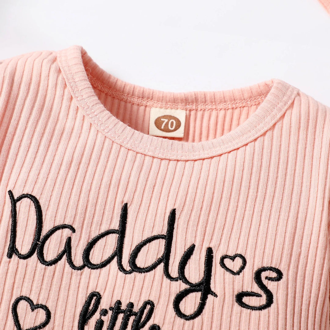 Ribbed pink romper neckline with black script lettering