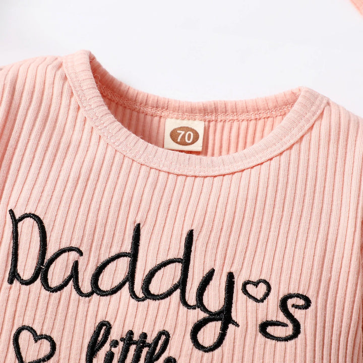 Ribbed pink romper neckline with black script lettering