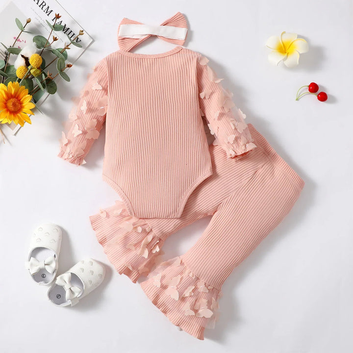 Back view of the pink ribbed romper beside matching butterfly-trimmed pants