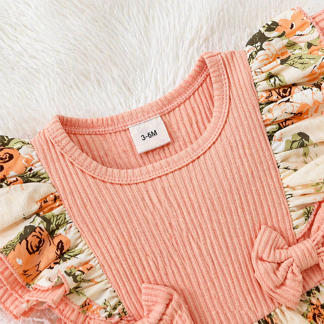 Pink ribbed neckline and floral ruffle sleeve detail on the baby romper